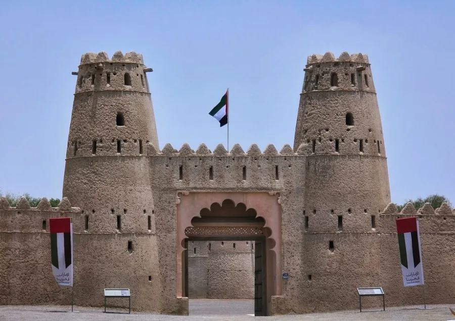 Historic Al Jahili Fort in Al Ain, Abu Dhabi, showcasing traditional architecture under a clear blue sky.